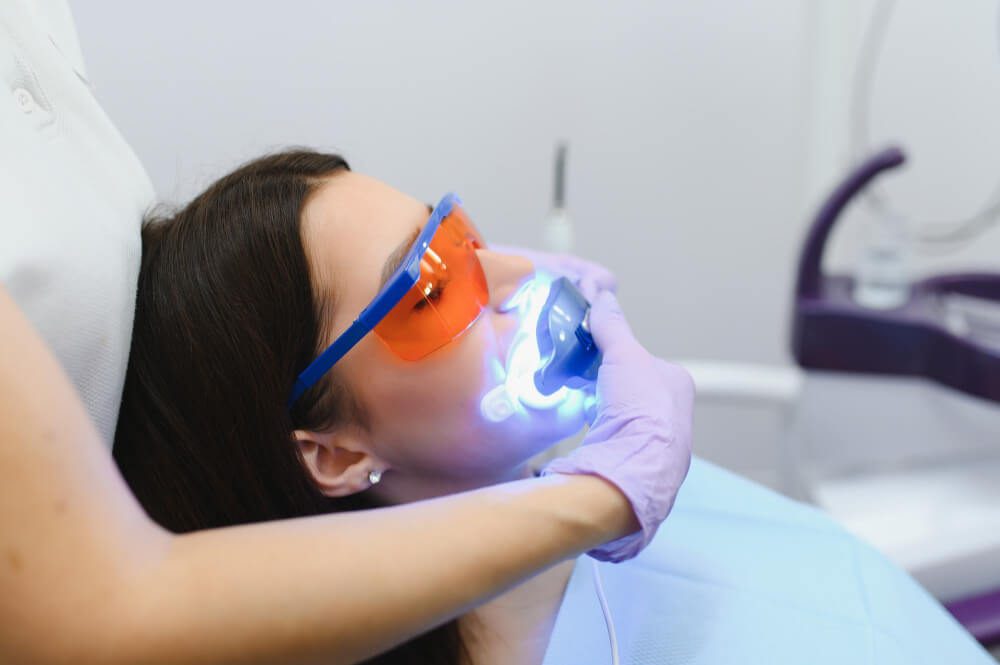 Woman receiving a professional teeth whitening treatment in Gordon dental clinic