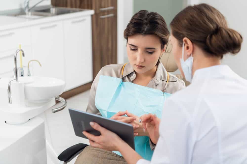 Dentist reviewing a dry mouth treatment plan with a patient at a dental clinic in Gordon