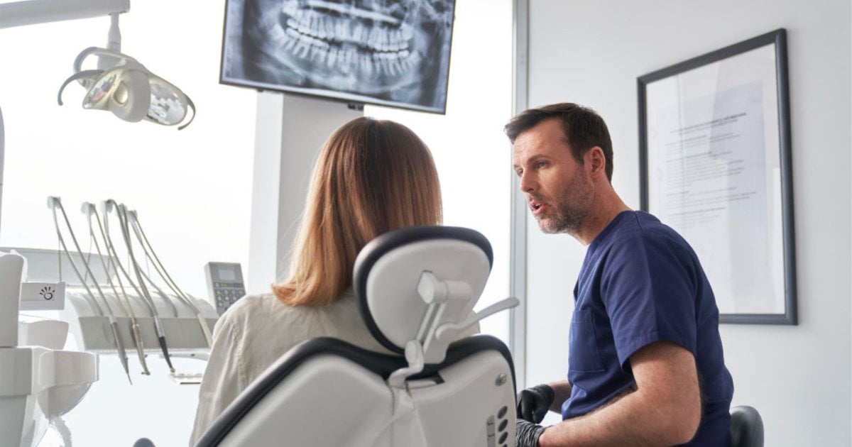 Dentist reviewing Invisalign treatment plan in Gordon