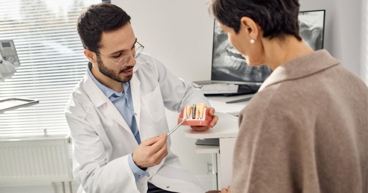 Dentist reviewing a dental implant plan with a patient in Gordon