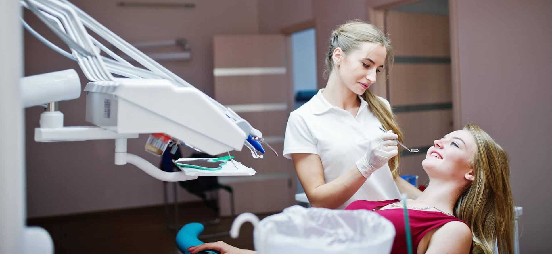 Dentist examining patient in clinic.